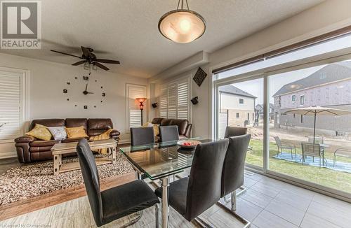 Dining room featuring light hardwood / wood-style floors, a wealth of natural light, a textured ceiling, and ceiling fan - 14 Greyhawk Street, Kitchener, ON - Indoor