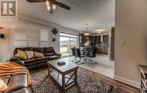 Living room featuring hardwood / wood-style floors, ceiling fan, and a textured ceiling - 14 Greyhawk Street, Kitchener, ON - Indoor Photo Showing Living Room