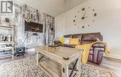 Living room featuring hardwood / wood-style floors and vaulted ceiling - 