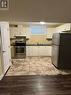 Kitchen with white cabinetry, appliances with stainless steel finishes, sink, and light hardwood / wood-style flooring - 111 Dallan Drive, Guelph, ON  - Indoor Photo Showing Kitchen With Double Sink 