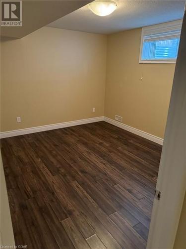 Unfurnished room featuring dark hardwood / wood-style floors - 111 Dallan Drive, Guelph, ON - Indoor Photo Showing Other Room