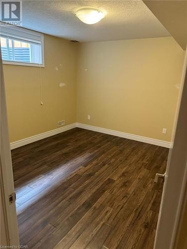 Basement featuring dark hardwood / wood-style floors and a textured ceiling - 111 Dallan Drive, Guelph, ON - Indoor Photo Showing Other Room