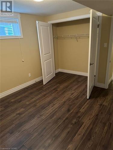 Unfurnished bedroom featuring dark wood-type flooring and a closet - 111 Dallan Drive, Guelph, ON - Indoor Photo Showing Other Room