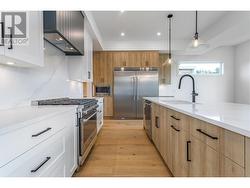 This kitchen offers loads of counter space, with high-end appliances and quartz countertops - 