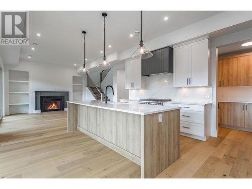 The home wows you with its open concept,  and also boasts the large walk-through Pantry Area - 907 Bull Crescent Lot# 91, Kelowna, BC - Indoor Photo Showing Kitchen With Upgraded Kitchen