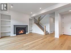 The view of your Living area with gas fireplace and custom built-in shelves - 