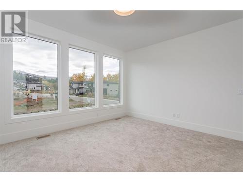 The Primary Suite with beautiful large windows located on the second floor - 907 Bull Crescent Lot# 91, Kelowna, BC - Indoor Photo Showing Other Room