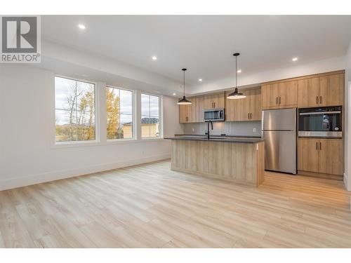 This Suite area encompasses your living area as well as the stunning kitchen featuring granite countertops - 907 Bull Crescent Lot# 91, Kelowna, BC - Indoor Photo Showing Kitchen