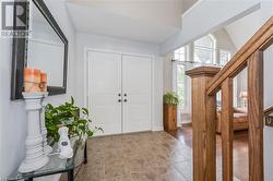 Tiled entryway featuring vaulted ceiling - 