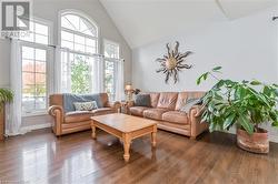 Living room with high vaulted ceiling and dark hardwood / wood-style flooring - 