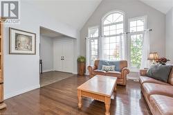 Living room featuring high vaulted ceiling and dark hardwood / wood-style floors - 