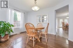 Dining area featuring dark wood-type flooring - 