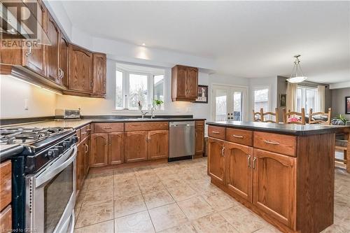 Kitchen featuring french doors, stainless steel appliances, a center island, sink, and decorative light fixtures - 43 Marr Drive, Elora, ON - Indoor Photo Showing Kitchen