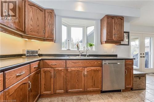 Kitchen with french doors, plenty of natural light, stainless steel dishwasher, and sink - 43 Marr Drive, Elora, ON - Indoor Photo Showing Kitchen With Double Sink