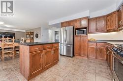 Kitchen featuring a center island and stainless steel appliances - 