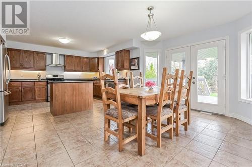 Dining room with french doors and light tile patterned floors - 43 Marr Drive, Elora, ON - Indoor