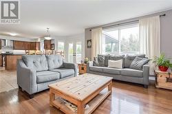 Living room featuring dark wood-type flooring and french doors - 