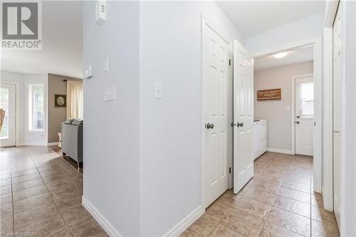 Hallway featuring washing machine and dryer, a healthy amount of sunlight, and light tile patterned flooring - 43 Marr Drive, Elora, ON - Indoor Photo Showing Other Room