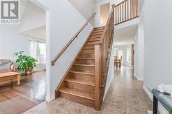 Stairs with high vaulted ceiling and hardwood / wood-style flooring - 