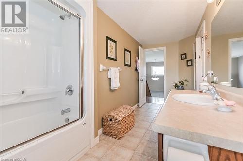 Bathroom featuring tile patterned flooring, shower / bath combination with glass door, and vanity - 43 Marr Drive, Elora, ON - Indoor Photo Showing Bathroom