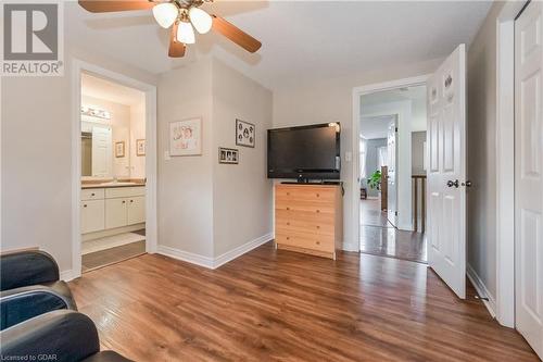 Living room with dark wood-type flooring, sink, and ceiling fan - 43 Marr Drive, Elora, ON - Indoor