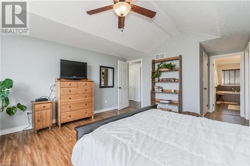 Bedroom with ensuite bath, a textured ceiling, hardwood / wood-style flooring, ceiling fan, and lofted ceiling with beams - 43 Marr Drive, Elora, ON - Indoor Photo Showing Bedroom