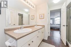 Bathroom featuring walk in shower, vanity, and tile patterned flooring - 