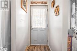 Doorway featuring dark wood-type flooring - 