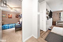 Hallway featuring hardwood / wood-style floors and crown molding - 