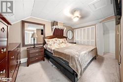 Bedroom with vaulted ceiling, light colored carpet, a closet, and crown molding - 