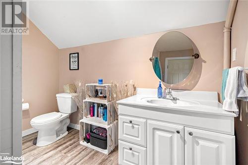 Bathroom featuring vanity, hardwood / wood-style flooring, toilet, and vaulted ceiling - 97 William Street, Parry Sound, ON - Indoor Photo Showing Bathroom