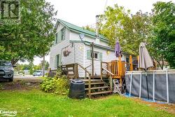 Back of house with a yard and a wooden deck - 