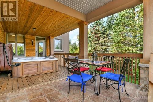 the covered outdoor space can be reclaimed to create a more formal dining room, works well for the Hot Tub. - 5844 Longhearth Way, Manotick, ON - Outdoor With Deck Patio Veranda With Exterior