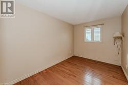 Unfurnished room with light hardwood / wood-style floors - 