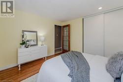 Bedroom featuring a closet and hardwood / wood-style flooring - 