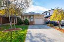 View of front facade featuring a garage, a porch, and a front yard - 46 Mark Place, Hamilton, ON 