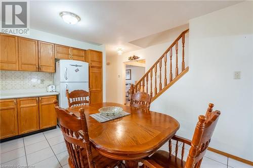 Dining room with light tile patterned floors - 46 Mark Place, Hamilton, ON 