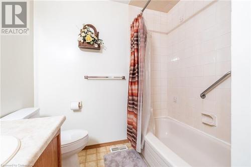 Full bathroom with tile patterned flooring, vanity, toilet, and shower / tub combo with curtain - 46 Mark Place, Hamilton, ON 