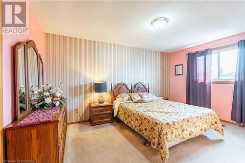 Bedroom featuring a textured ceiling and light carpet - 46 Mark Place, Hamilton, ON 