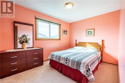 Bedroom featuring light colored carpet and a textured ceiling - 46 Mark Place, Hamilton, ON 