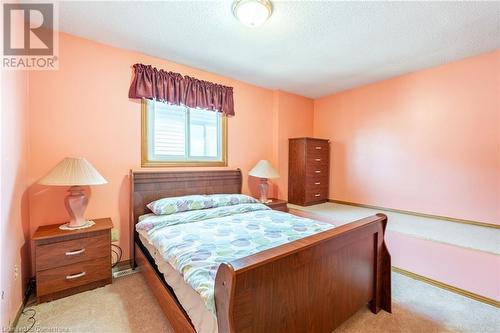 Bedroom with a textured ceiling and light colored carpet - 46 Mark Place, Hamilton, ON 