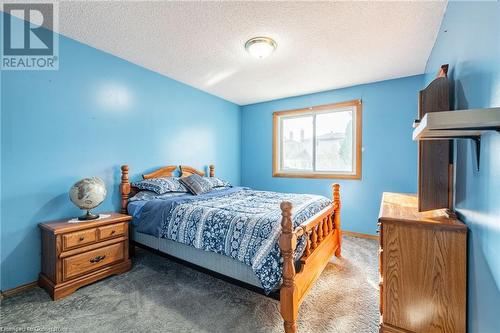 Carpeted bedroom with a textured ceiling - 46 Mark Place, Hamilton, ON 