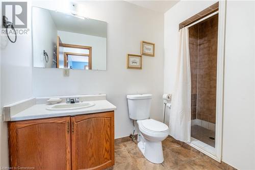 Bathroom with toilet, a shower with curtain, vanity, and tile patterned flooring - 46 Mark Place, Hamilton, ON 