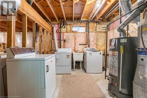 Washroom with separate washer and dryer, gas water heater, and sink - 46 Mark Place, Hamilton, ON 