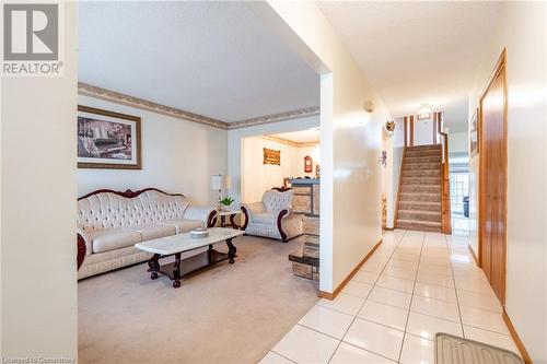 Carpeted living room with a textured ceiling - 46 Mark Place, Hamilton, ON 