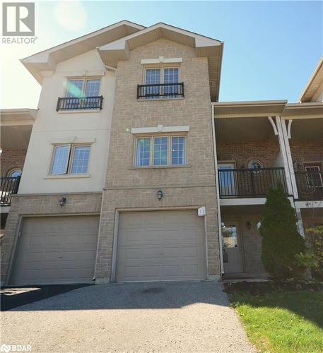 View of property with a garage - 175 Stanley Street Unit# 11, Barrie, ON - Outdoor With Balcony