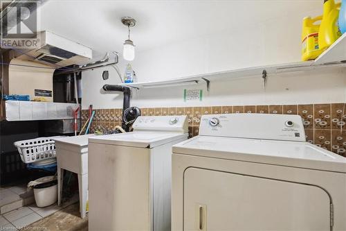 Washroom featuring washing machine and dryer and light tile patterned floors - 63 Clyde Street, Hamilton, ON - Indoor Photo Showing Laundry Room