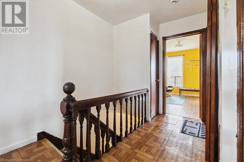 Corridor featuring dark parquet flooring - 63 Clyde Street, Hamilton, ON - Indoor Photo Showing Other Room