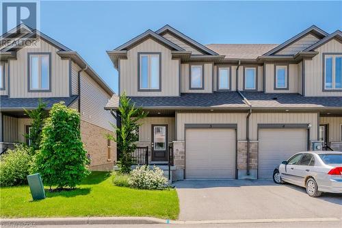 View of front of home featuring a garage and a front yard - 1023 Devonshire Avenue Unit# 3, Woodstock, ON - Outdoor With Facade