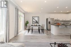 Dining area with light  wood-style flooring and sink - 